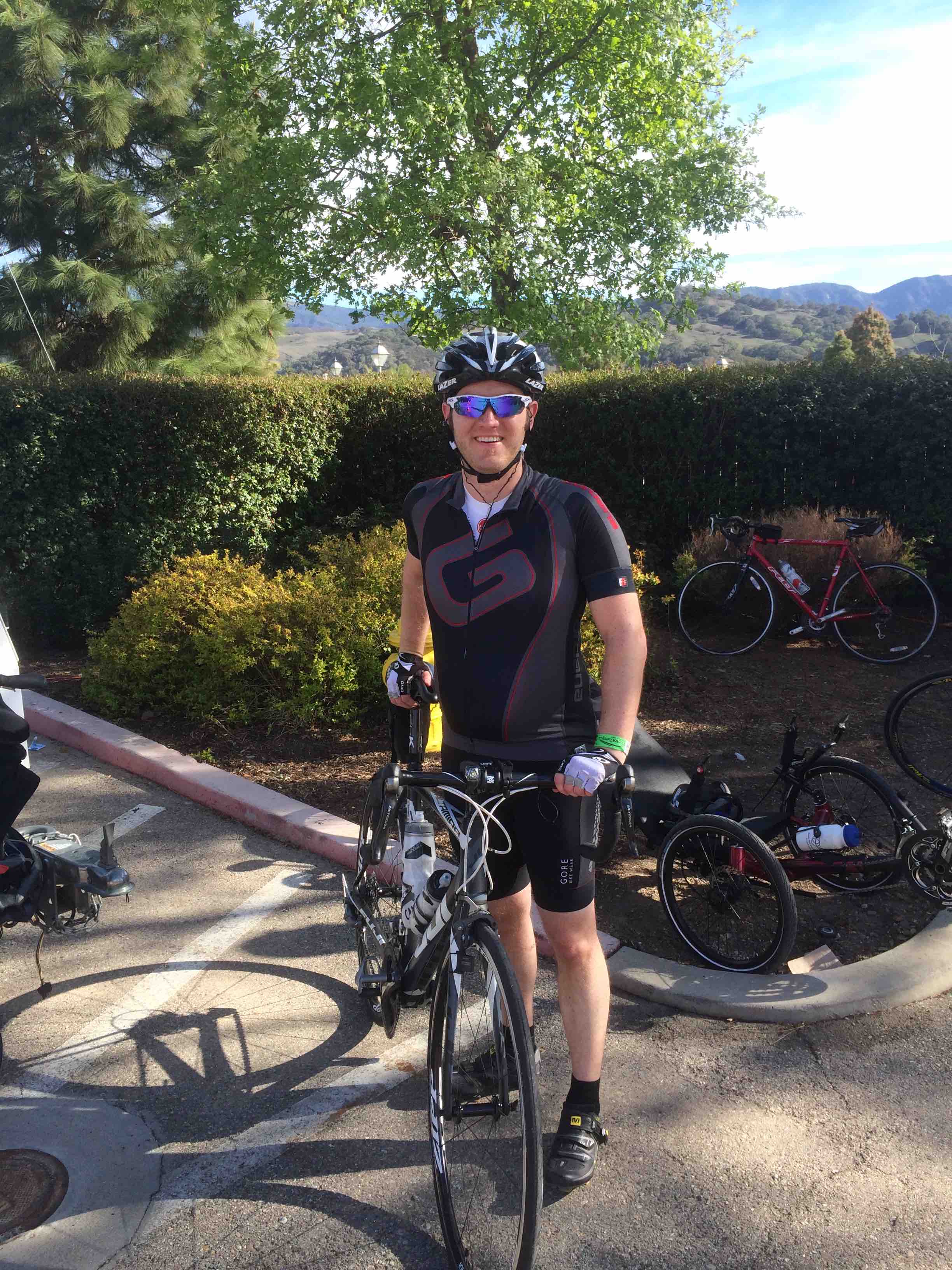 Cyclist leaning on bike at end of 2014 Solvang Century cycling event
