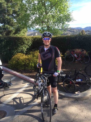 Cyclist leaning on bike at end of 2014 Solvang Century cycling event