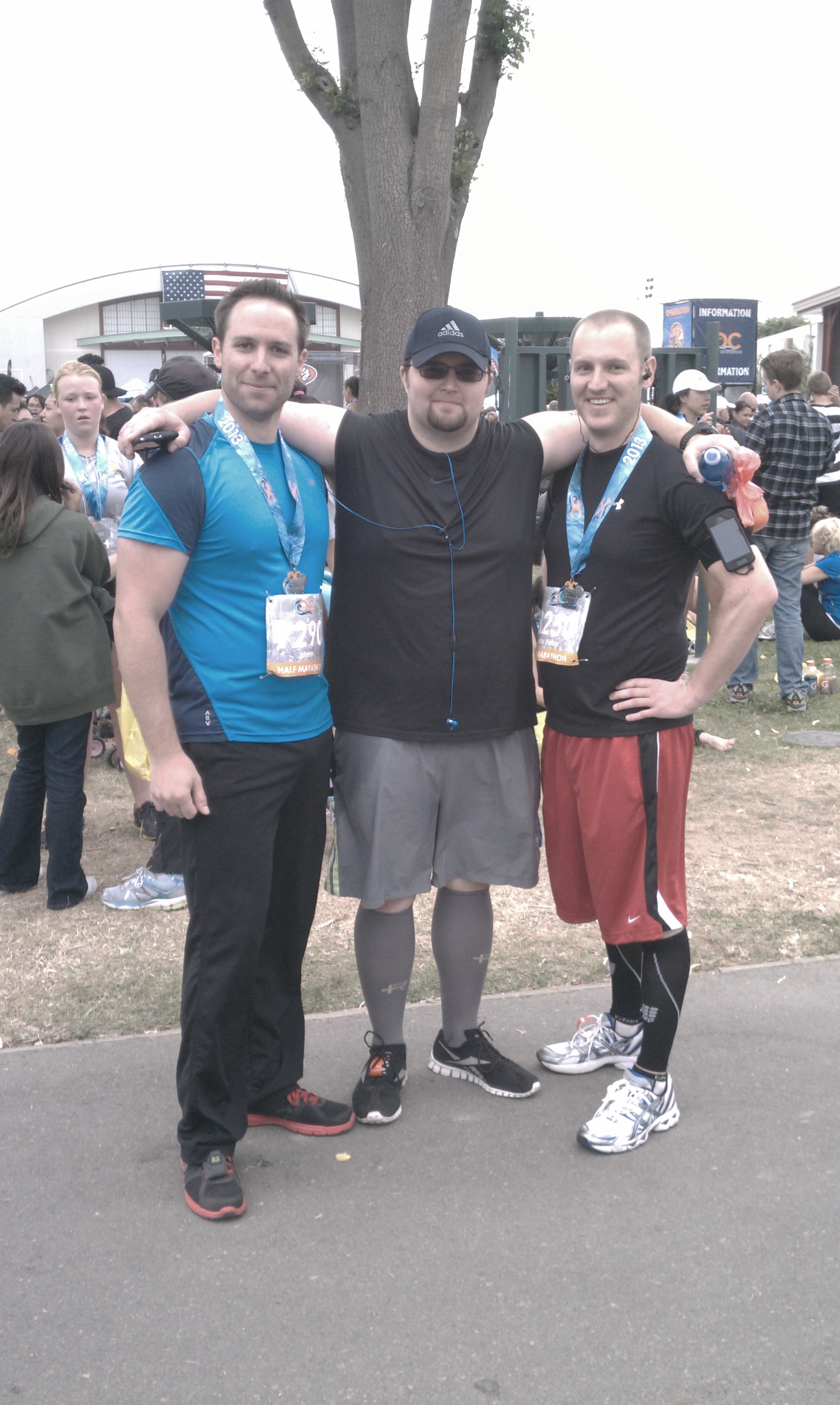 Arms around friends after running the Orange County half marathon event