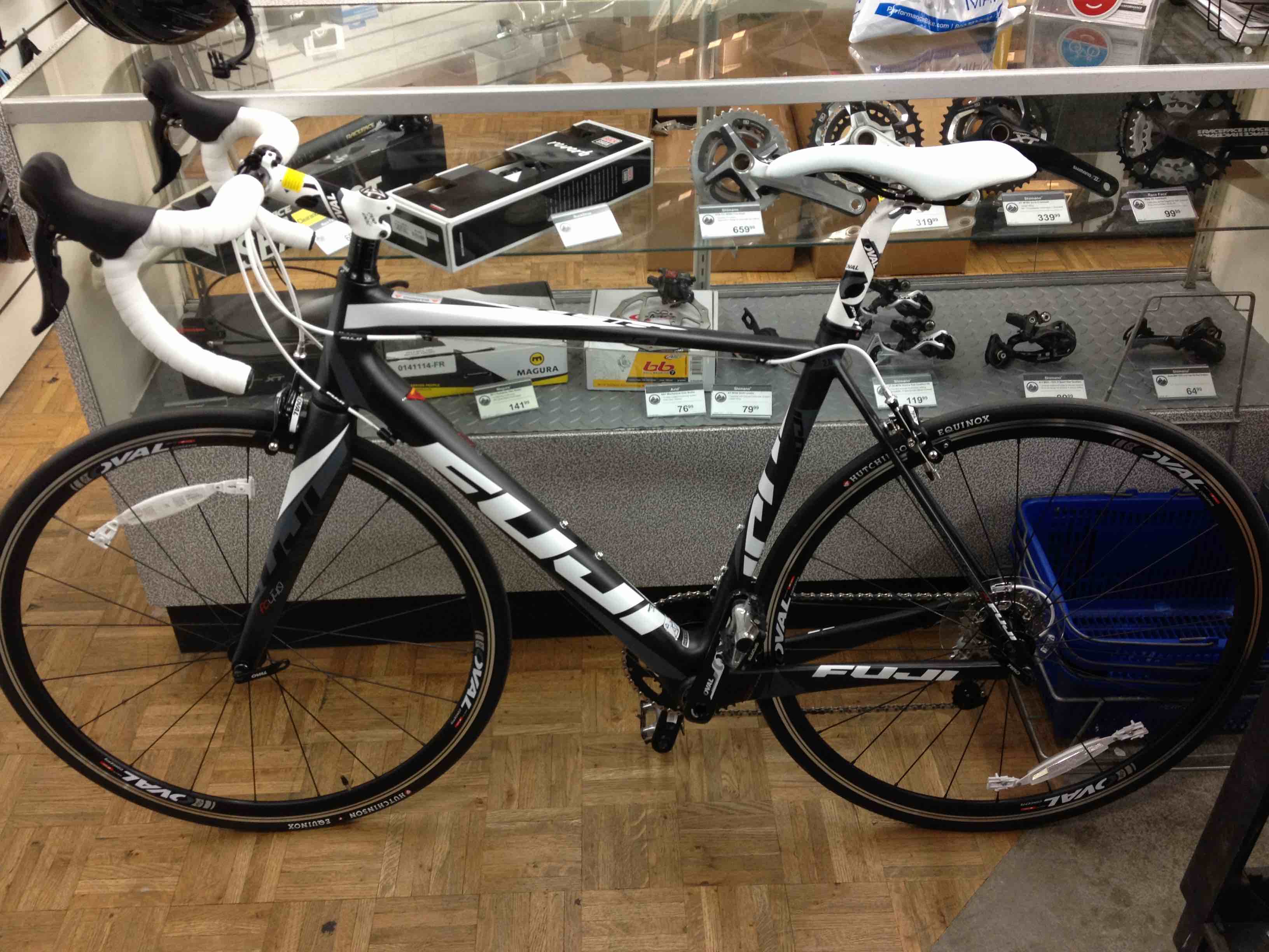 2013 Fuji Altamira first road bike leaning against glass in store at Performance Bicycle