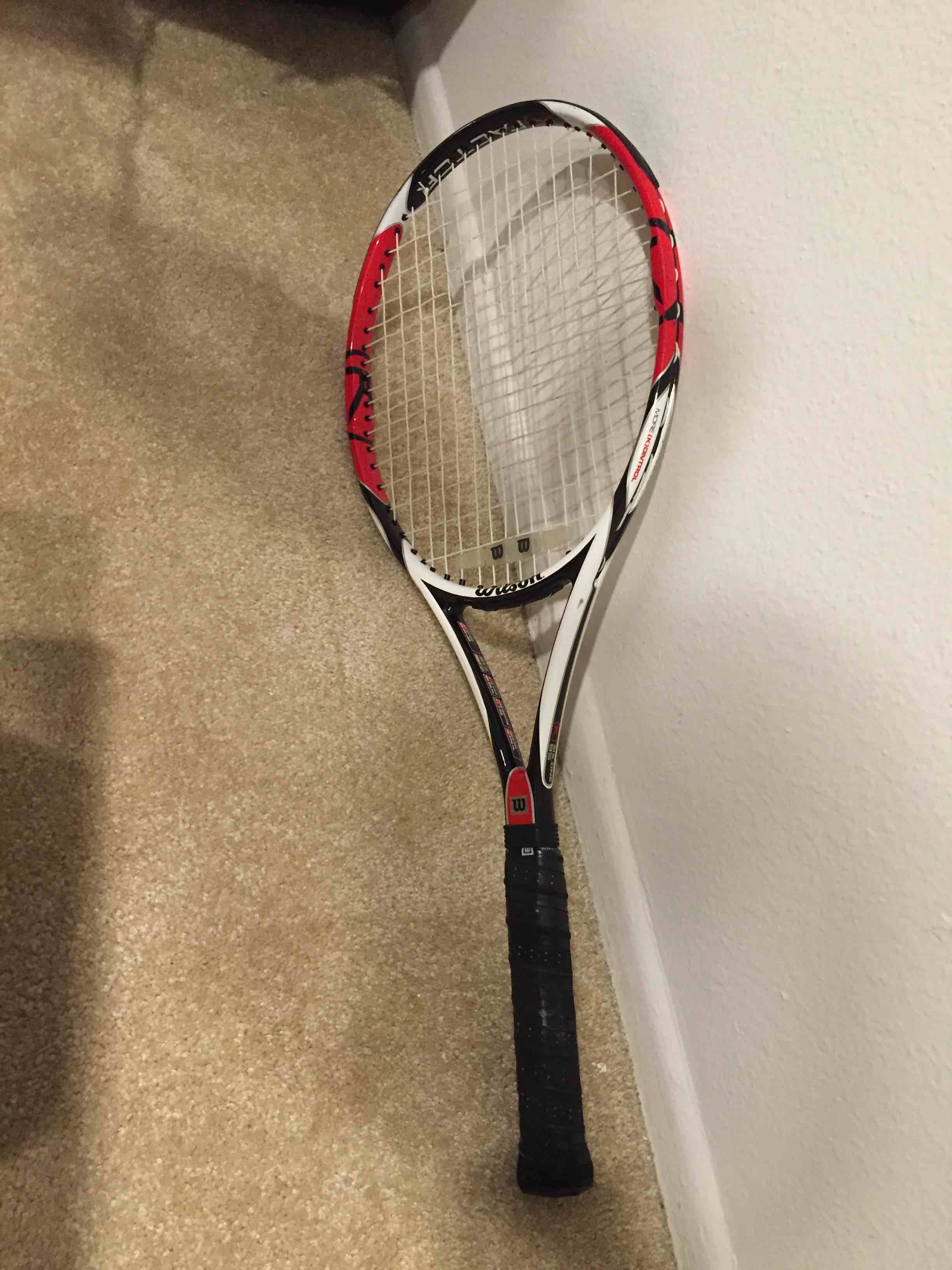 Roger Federer's Wilson branded tennis racquet laying on floor