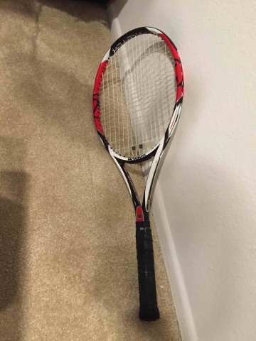 Roger Federer's Wilson branded tennis racquet laying on floor