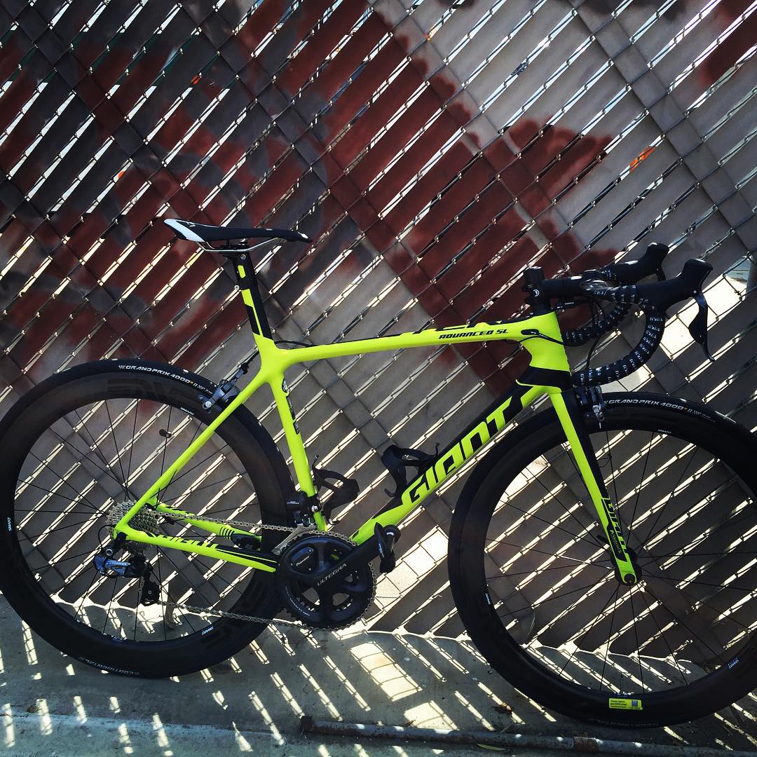 2016 Giant TCR Advanced SL bicycle leaning against a fence with Enve 4.5 wheels