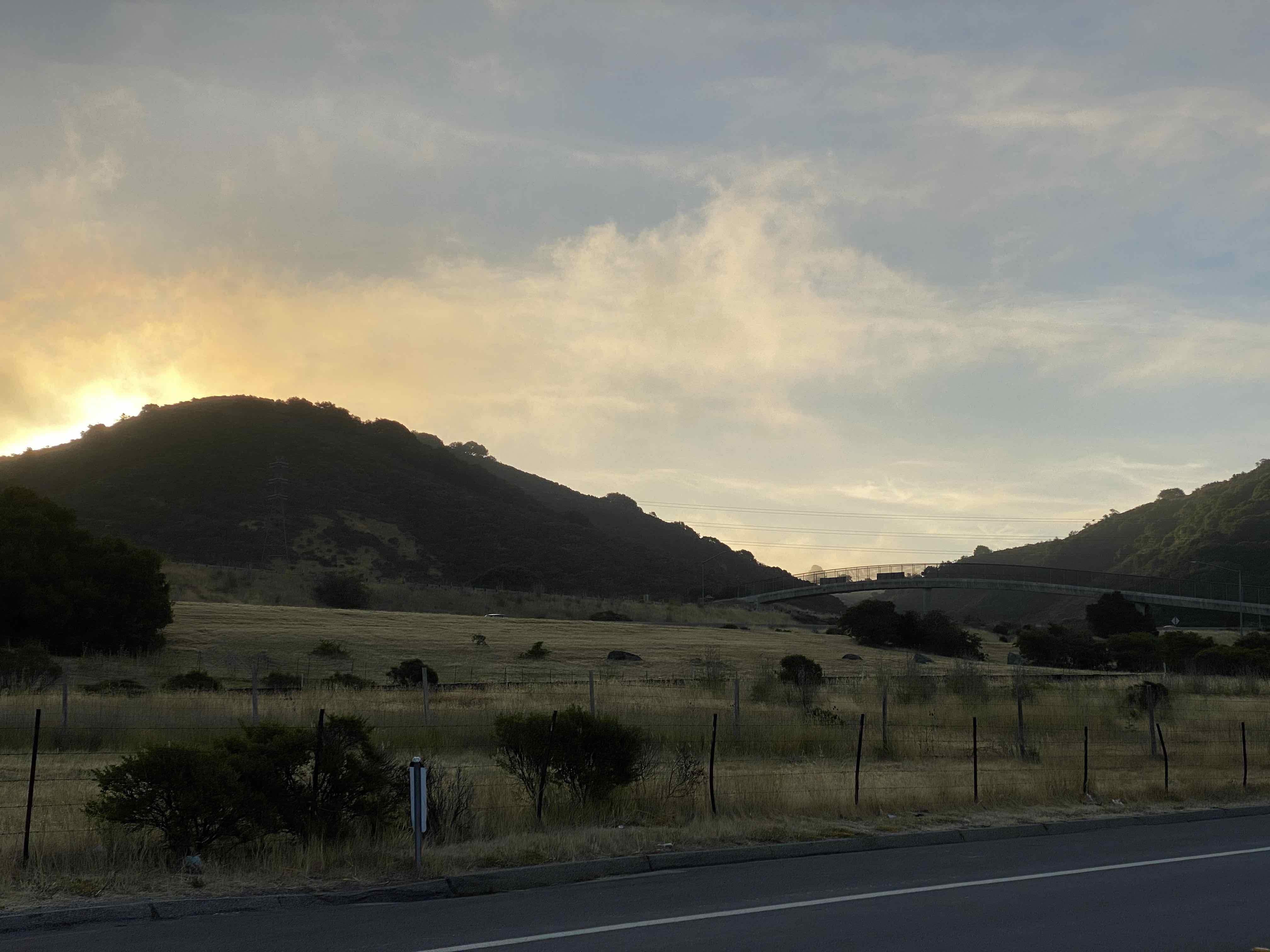 Sun rising over mountain along Canada road near San Mateo, California