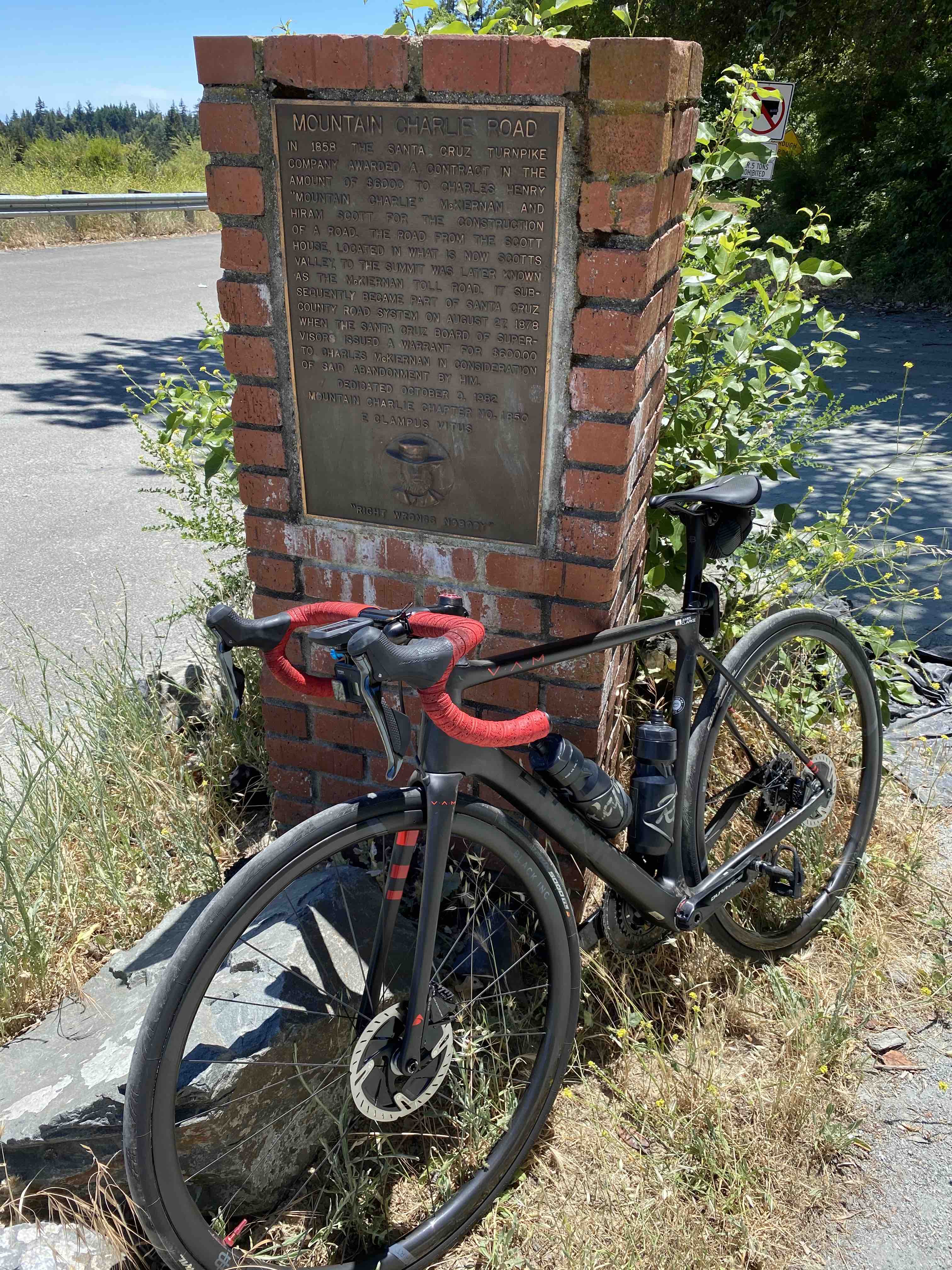 Bicycle posed against brick road marker for Mountain Charlie Road in the Santa Cruz mountains
