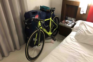 Getting around with a bike carrier can be tricky in some international destinations like Europe, but with some planning, it doesn't have to be difficult. Image contains: Giant TCR bicycle, BikeBoxAlan bike box case, hotel bedroom, tool bag, charging cables.