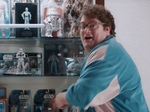 Man in front of action figures saying awesome gif