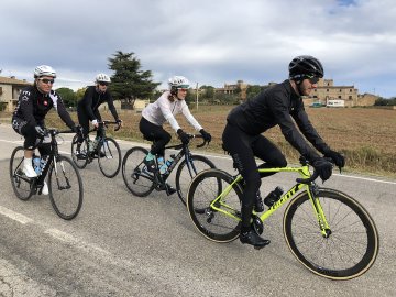 Group of cyclists riding in the Spanish countryside, outside of Girona, Spain