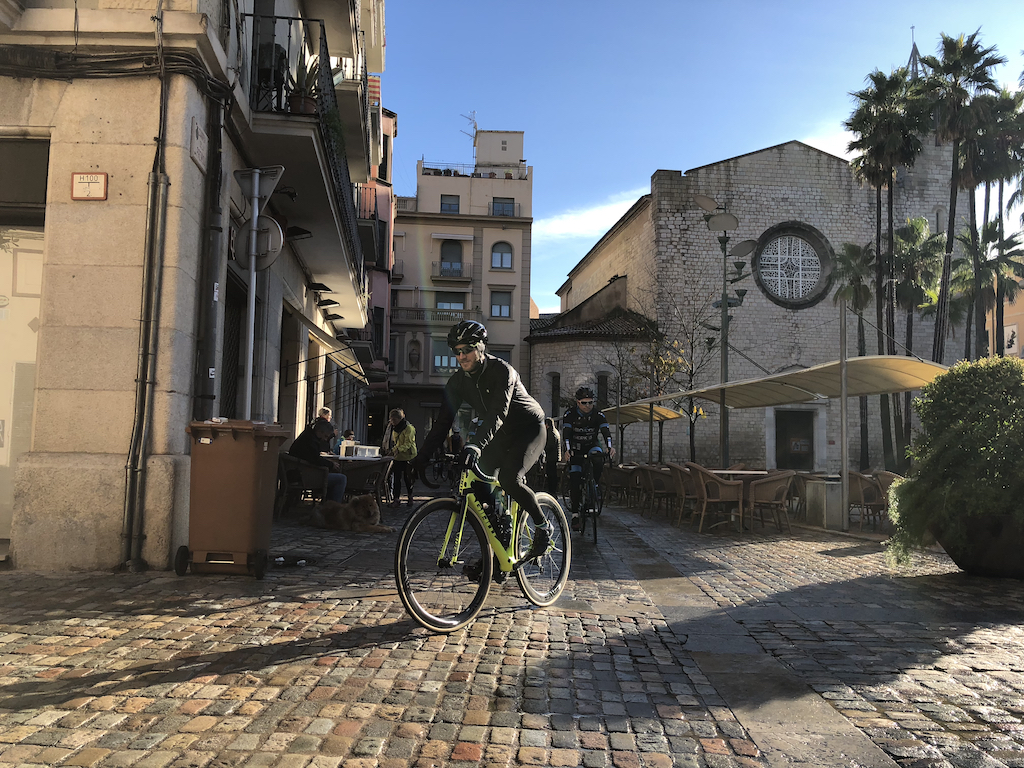 Cyclist riding through old town Girona, Spain