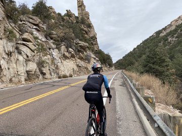 Cyclist wearing Pas Normal Studios gear ascending Mt. Lemmon in Tucson, Arizona