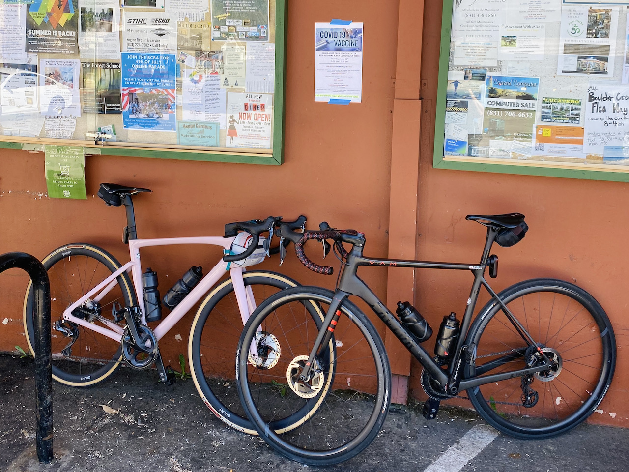 Two bikes leaning against a store wall in Boulder Creek, CA.