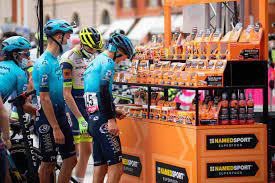 You see their stuff all over the pro circuit these days Professional bike riders looking at a NamedSport booth at a major event