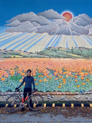 A fun mural out near Terun in Palo Alto Cyclist in front of mural in Palo Alto, California, near the California Street Caltrain station stop