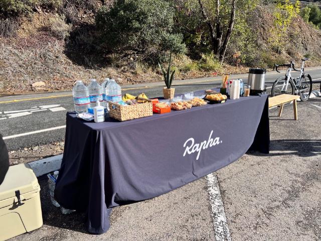 A table of snacks set out by Rapha for a group of cyclists at a rest stop in Silverado, California