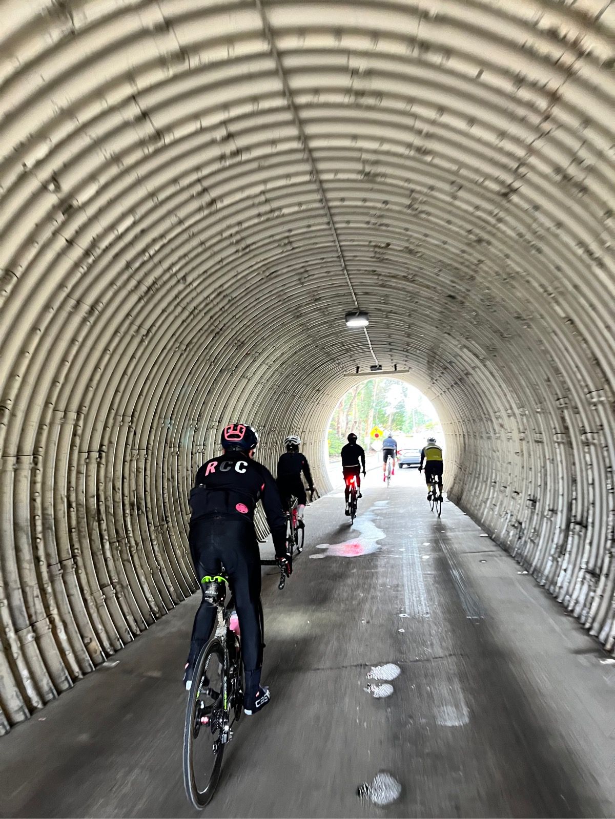 Cyclists riding through a tunnel in Orange County, California