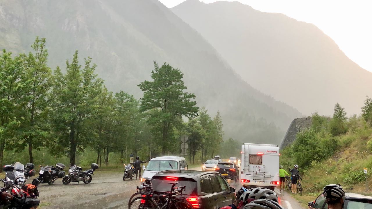 Cyclists and cars stuck behind an avalanche near La Grave, France after watching the Galibier stage of the 2019 Tour de France