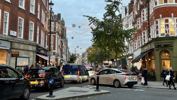 Even they aren't really sharing with each other! Cars in traffic along a small road in London