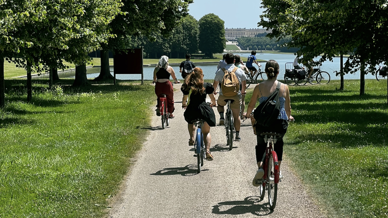 Cyclists riding the grounds of the Palace of Versailles
