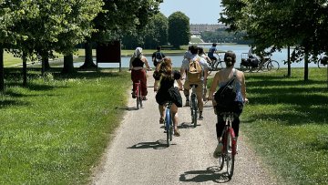 Casually cruising around the Palace of Versailles Cyclists riding the grounds of the Palace of Versailles
