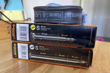 Make sure to err a bit on a side of caution here! Stacked Continental branded bicycle tire tubes in boxes showing their valve stem lengths