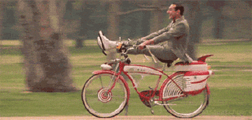 Peewee Herman riding his bike without a care in the world