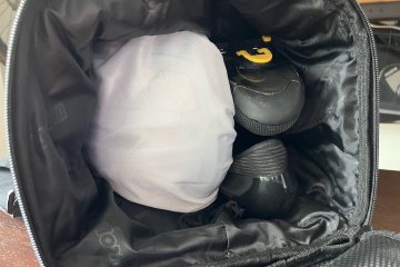 Inside view of the ScIcon Race Day Rain bag with helmet tilted sideways fitting two stacked shoes