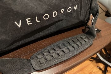 Strap used for carrying the ScIcon Race Day Rain Bag on table next to bag