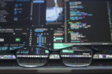 Google search "stock image" and you'll get all kinds of stuff like this one! Stock image of glasses in front of code on a computer screen