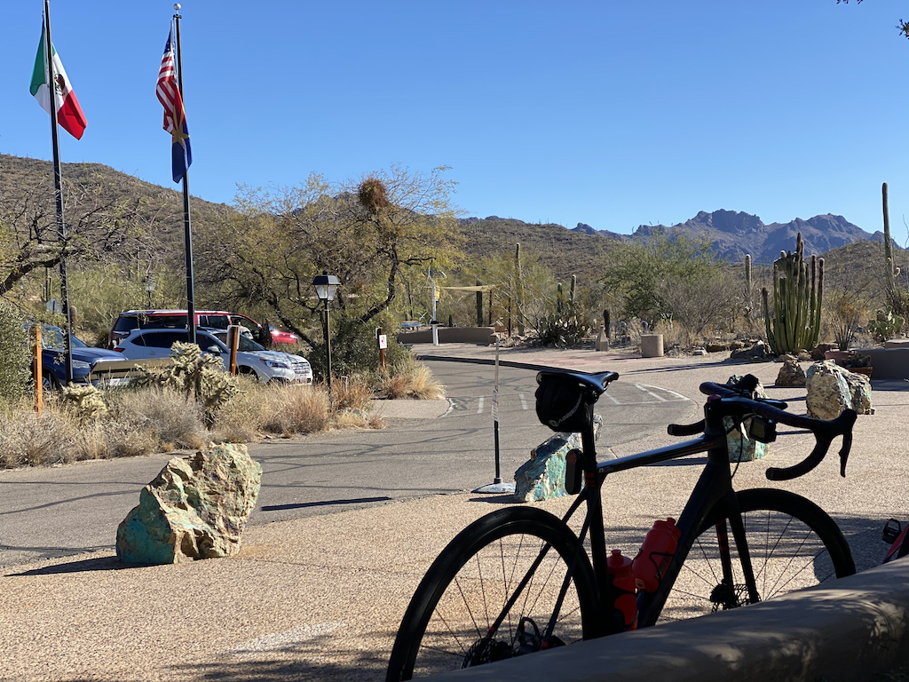 Bicycle leaning against a wall overlooking several flags at the Arizona-Sonora Desert Museum near Tucson, Arizona