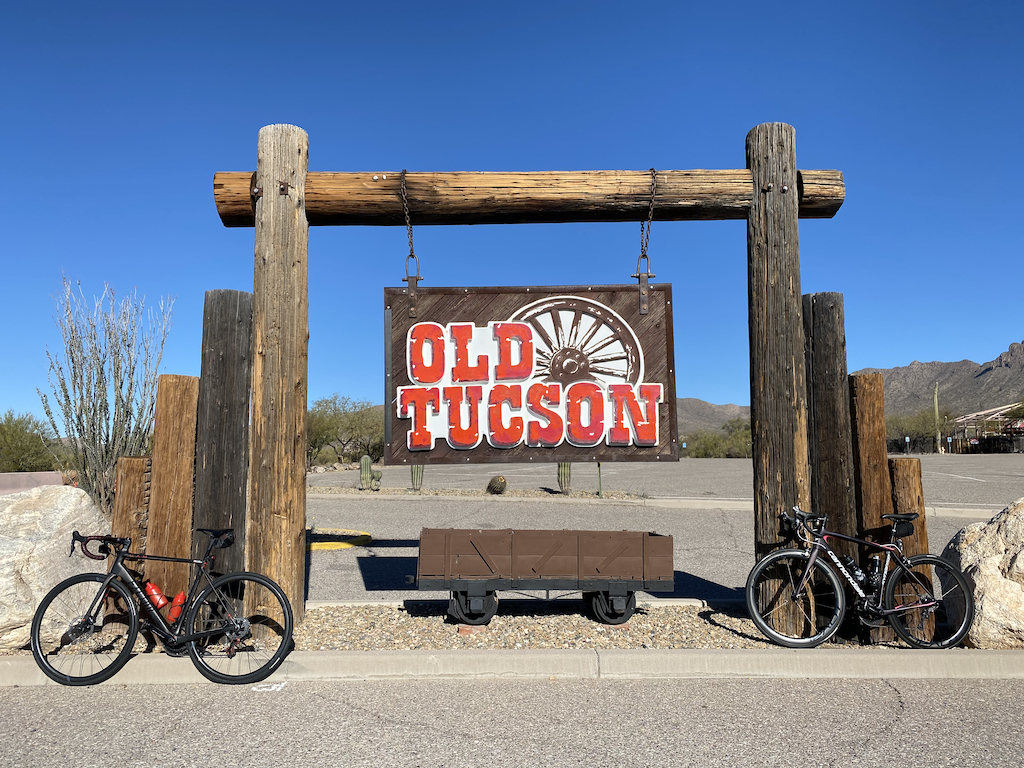 Two bicycles parked next to the sign outside Old Tucson, a tourist attraction near Tucson, Arizona