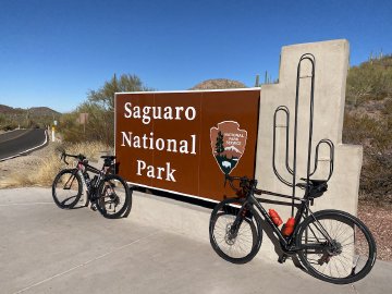 That road behind this sign truly was fantastic. Bicycles leaning against the entry sign for the Saguaro National Park West near Tucson, Arizona