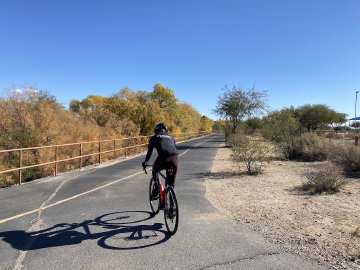 Off we go! Cyclist entering The Loop bicycle and mixed-use pathway in Tucson, Arizona