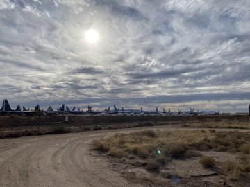 It's hard to really understand just how big each of these are! Distance view of an airplane boneyard with decommissioned planes in view.
