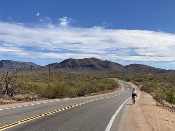 Seriously one of my favorite pictures I've taken. Lone cyclist traveling along winding road near the east side of Tucson, Arizona.