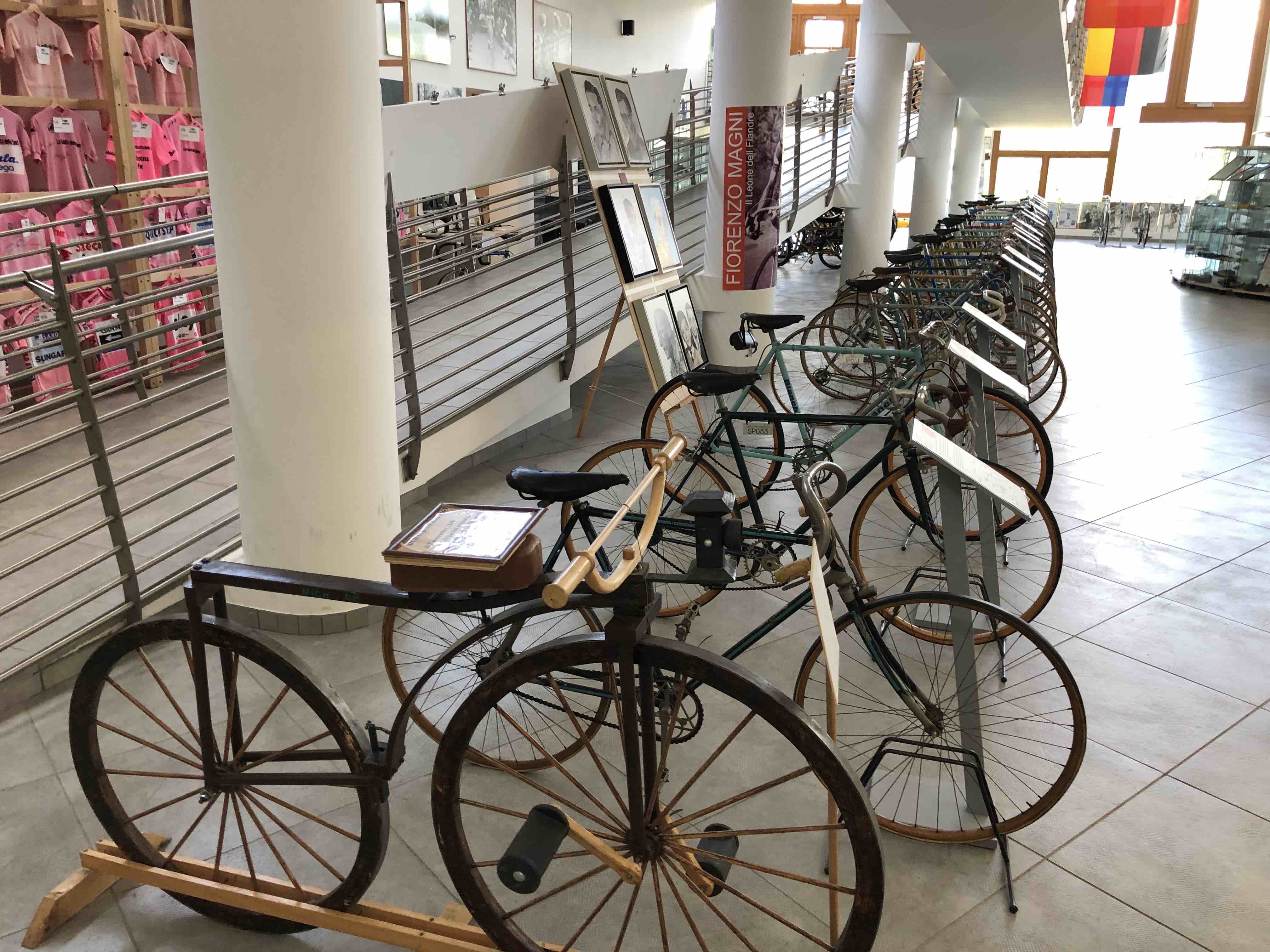 Old bicycles ranging over 100 years of history parked in a row inside the Museo del Ciclismo, a cycling museum