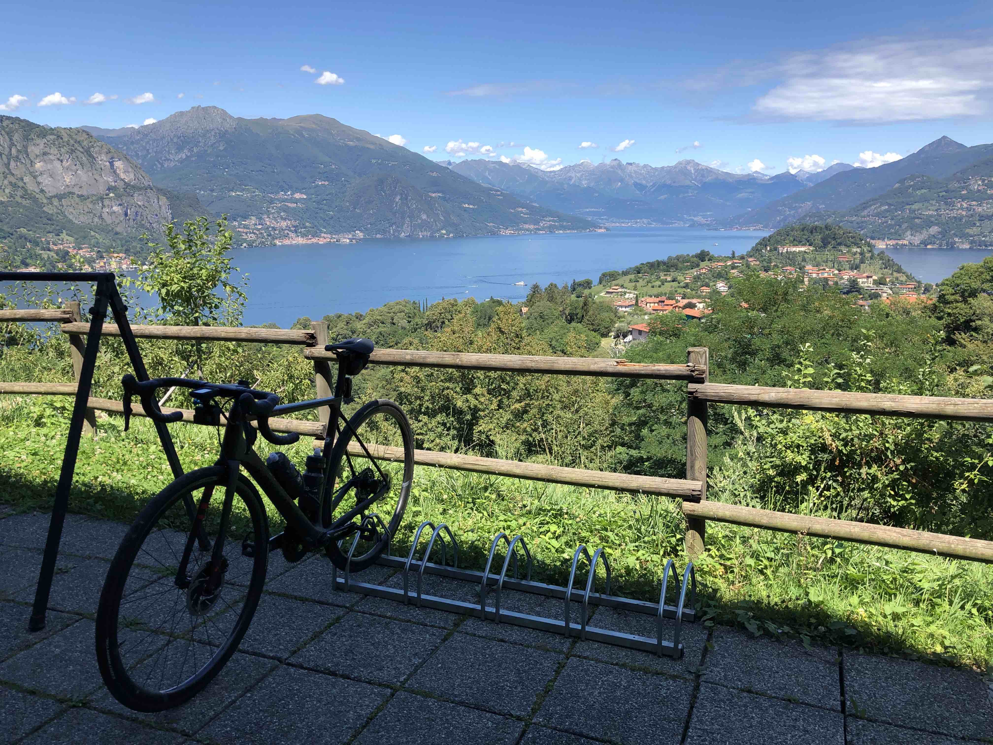 Bicycle hanging from rack with view out over Lake Como at the Como Lago Bike shop in Bellagio, Italy