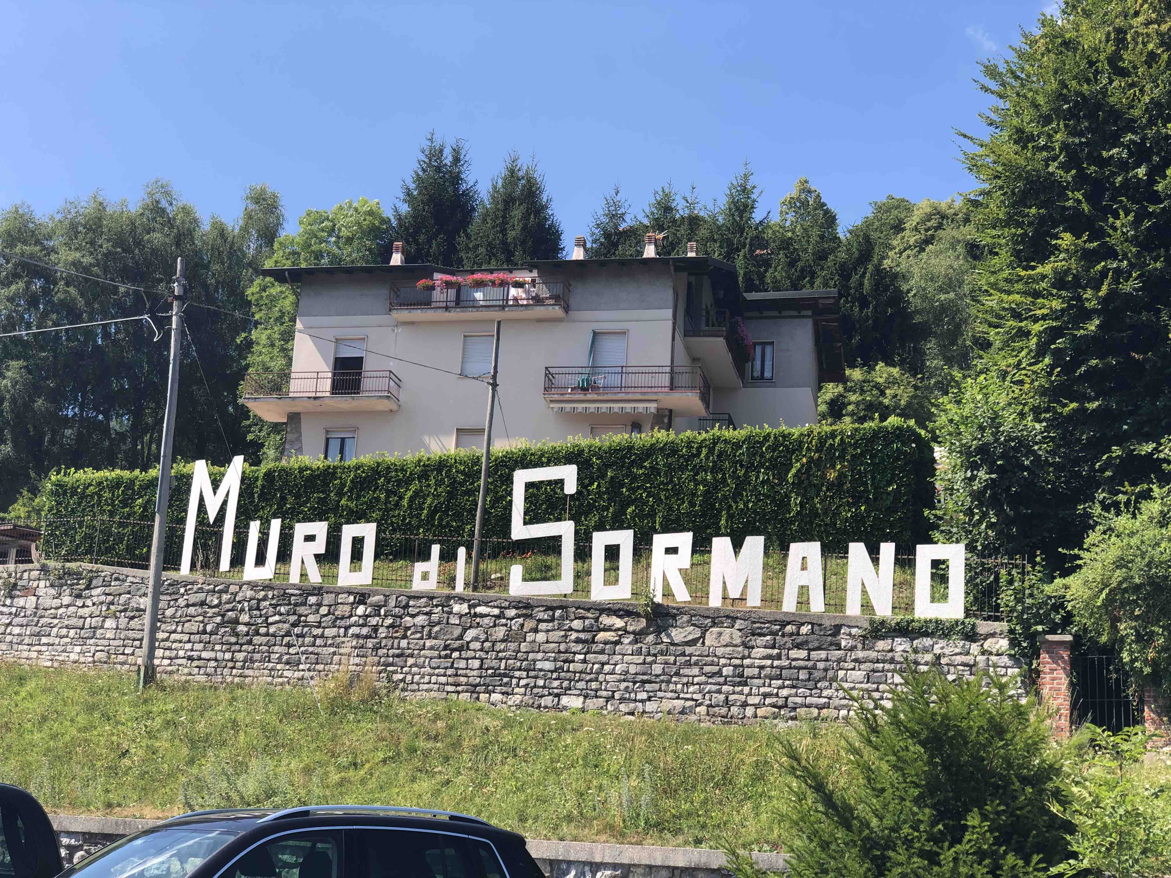 Cut out sign on a stone wall for the famous Muro di Sormano climb for cyclists