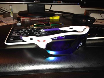 Never mind the mess! First pair of Oakley sunglasses on desk in front of keyboard