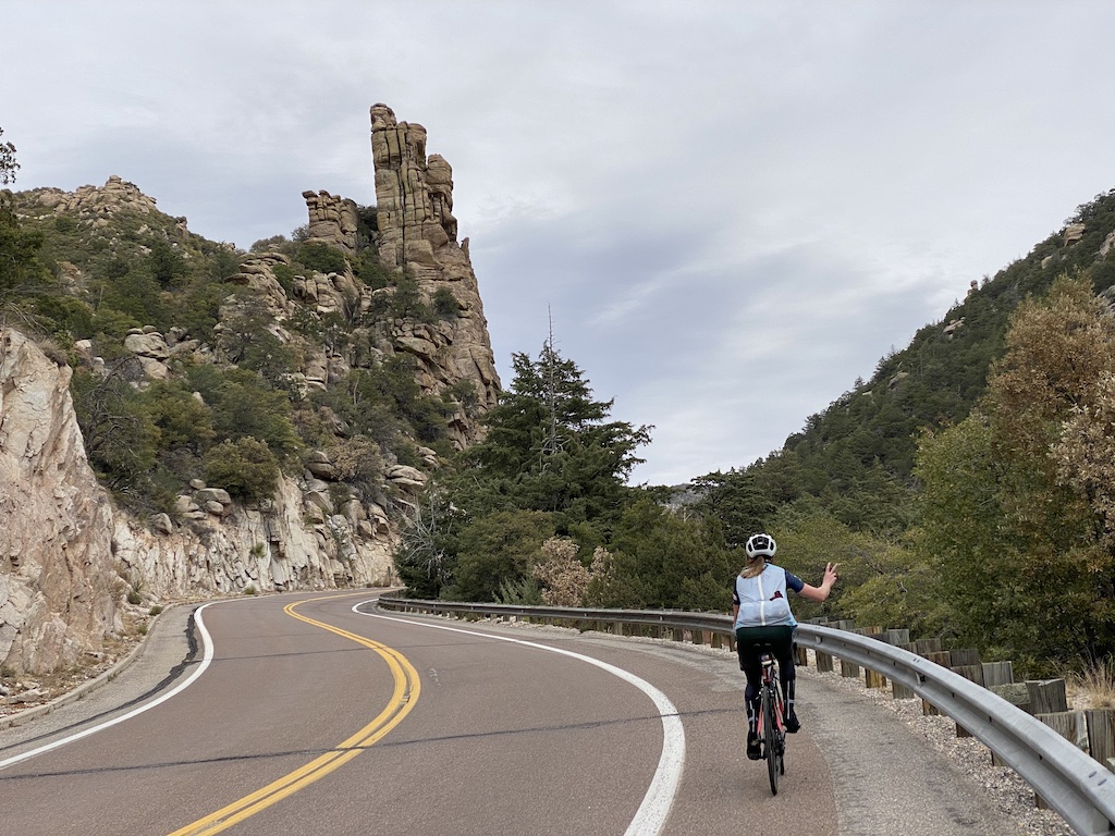 Cyclist with peace sign while riding along Catalina Highway on the way up to Mount Lemmon in Tucson, Arizona