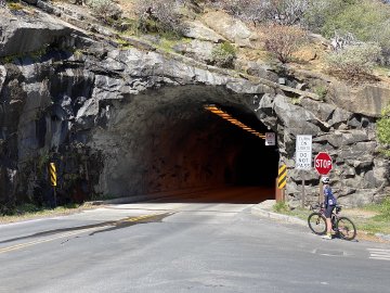 It's quite a large tunnel! Cyclist near the entrance of the Yosemite National Park Tunnel.