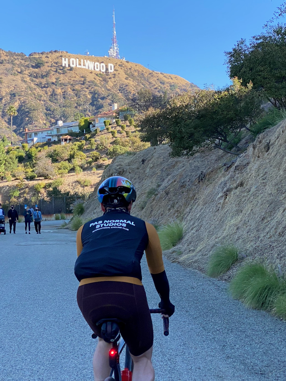 Cyclist looking up at the Hollywood Sign along the Hollywood Reservoir multi-use path