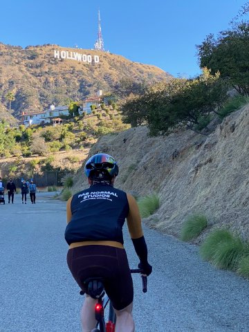 I'm glad to have found this route Cyclist looking up at the Hollywood Sign along the Hollywood Reservoir multi-use path