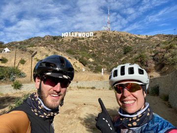 So excited! A cyclist couple about to ride up to the Hollywood Sign in Los Angeles, California