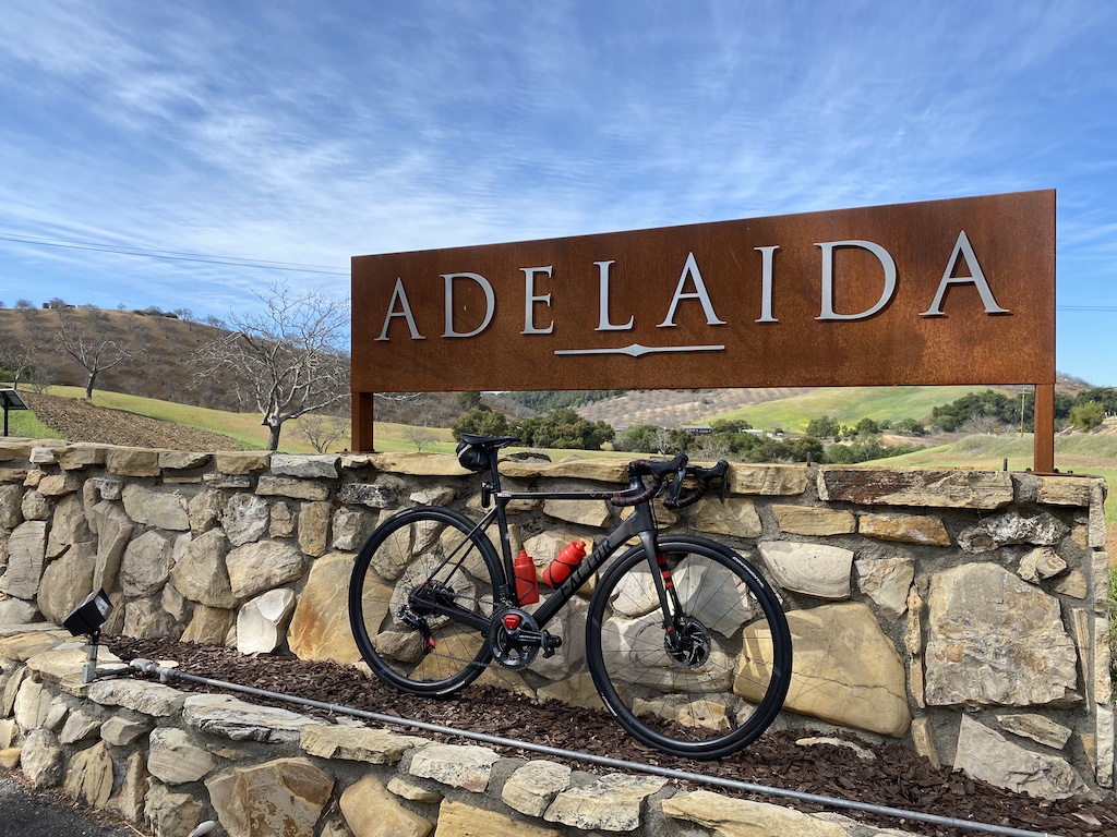 Factor O2 VAM bicycle resting on a stone wall at Adelaida Winery in Paso Robles, California