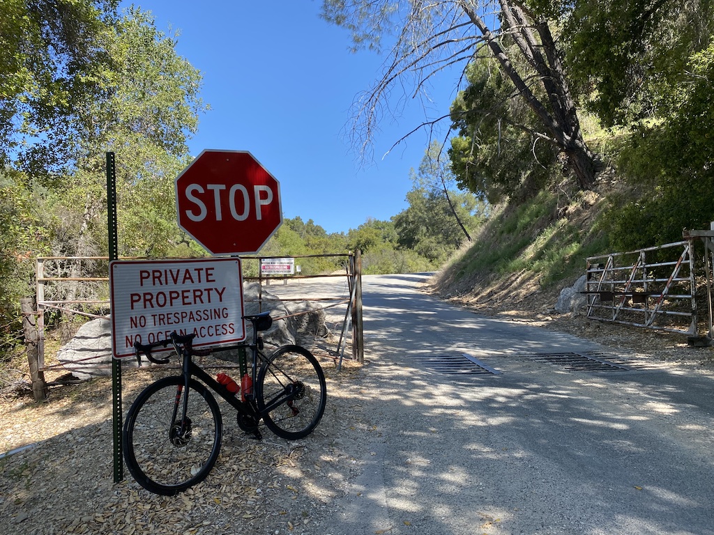 Factor O2 VAM bicycle leaning against a sign by Lime Mountain quarry, near Lake Nacimiento, California