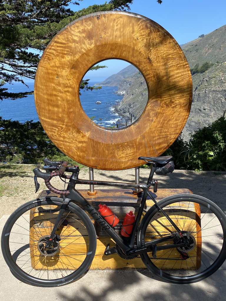 Factor O2 VAM bicycle leaning against the Portal to Big Sur statue in Ragged Point, California.