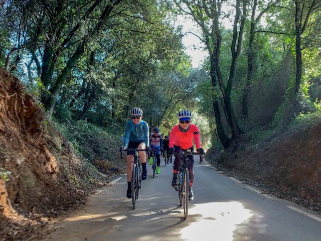 Cyclists near Cornelià del Terri riding in a group on their way to climbing Rocacorba in Girona, Spain