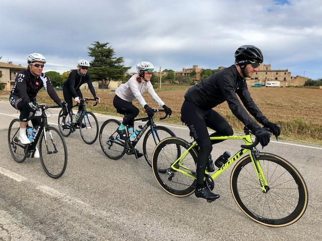 Several cyclists riding along in a group near Madremanya, Spain, on the back side of the famous Els Ángels climb.