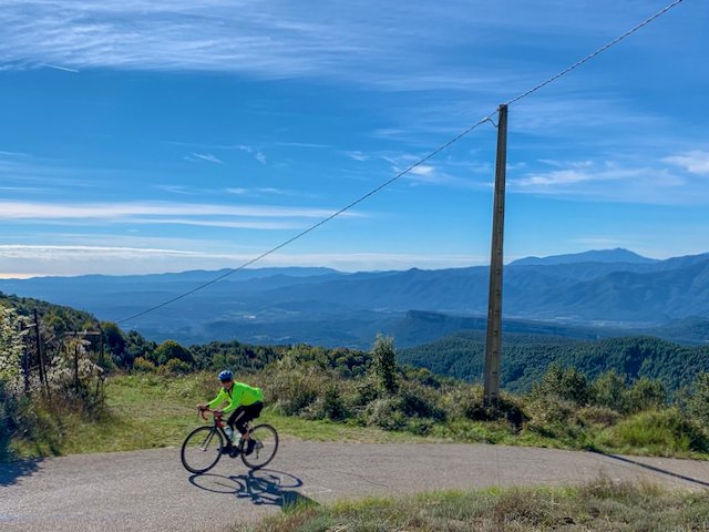 Cyclist climbing the infamous Rocacorba climb near Girona, Spain