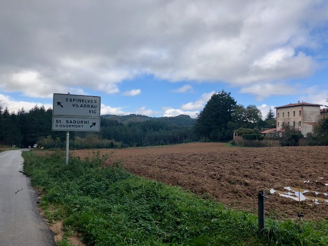 Street sign next to a farm near Sant Hilari de Sacalm